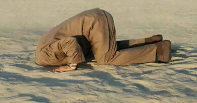 Homem com a cabeça enfiada na areia