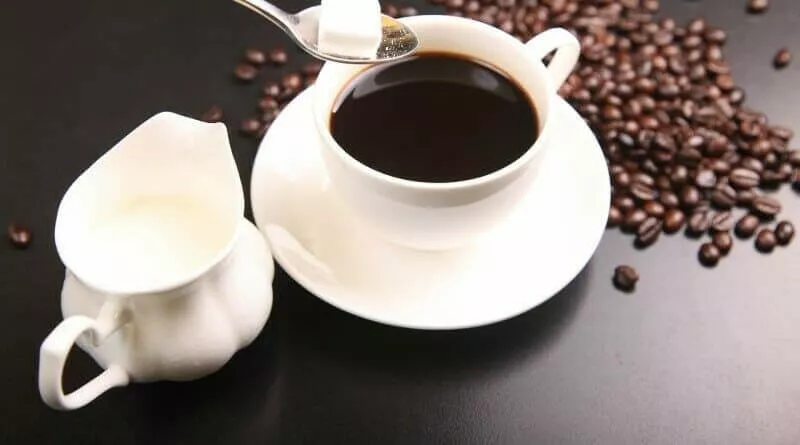 grãos e uma xícara de café